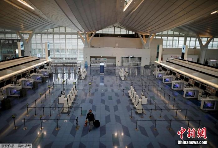 資料圖：日本東京，東京國際機場，一名乘客在國際航班航站樓的登機區(qū)。