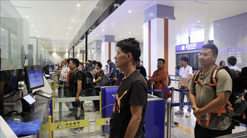 6月13日，乘坐中老鐵路國際旅客列車的旅客在磨憨邊檢大廳排隊候檢。李揚(yáng) 攝