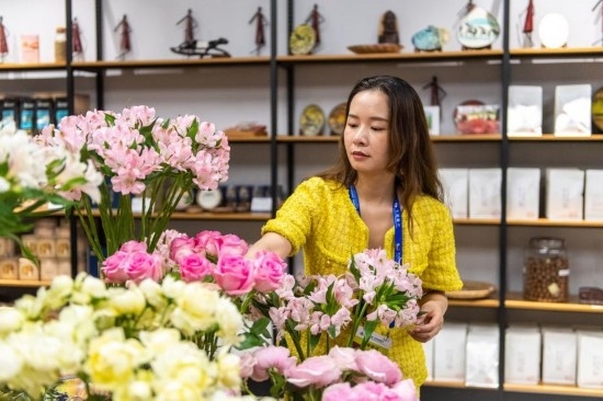 2023年7月1日，在位于湖南省長沙市的湖南高橋大市場，中非經(jīng)貿(mào)博覽會常設展館展區(qū)肯尼亞館工作人員在整理產(chǎn)自非洲的鮮花。新華社記者 陳思汗 攝