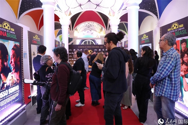 為期4天的第三屆中國－巴西電影展期間，來自中巴兩國的14部參展影片受到巴西電影愛好者和社會(huì)各界人士好評(píng)，圖為當(dāng)?shù)赜^眾在影展舉辦地巴西里約熱內(nèi)盧勞拉—阿爾維姆文化之家的迎賓廳欣賞參展電影海報(bào)。 人民網(wǎng)記者 陳一鳴攝