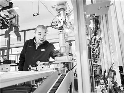 郭海青在檢查車床加工設(shè)備。 受訪者供圖