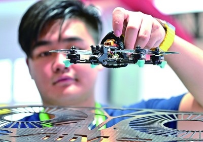 在首屆晉江科技成果轉(zhuǎn)化對接洽談會智能裝備展位，工作人員在展示無人機研究成果。新華社發(fā)