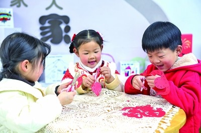 圖為孩子們在老師指導(dǎo)下制作蛇年主題剪紙。 新華社記者 徐昱攝